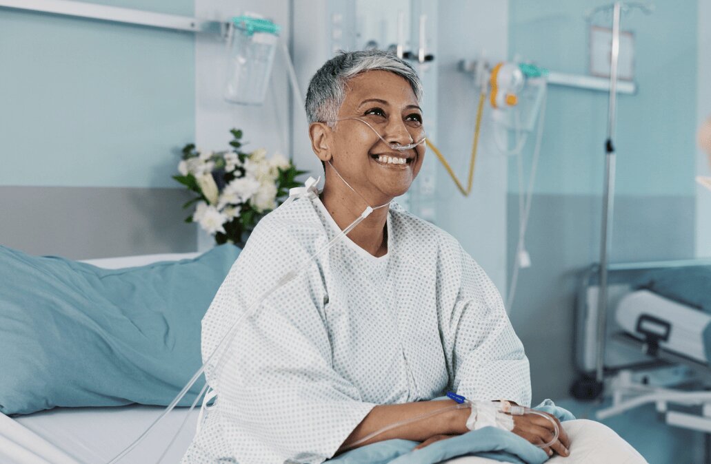 Nurse holds IV bag with tubing connected to a medical device